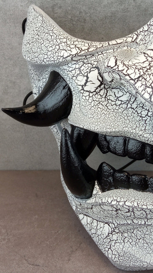 Black and white cracked samurai mask with black fangs