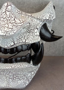 Black and white cracked samurai mask with black fangs
