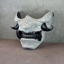 Black and white cracked samurai mask with black fangs