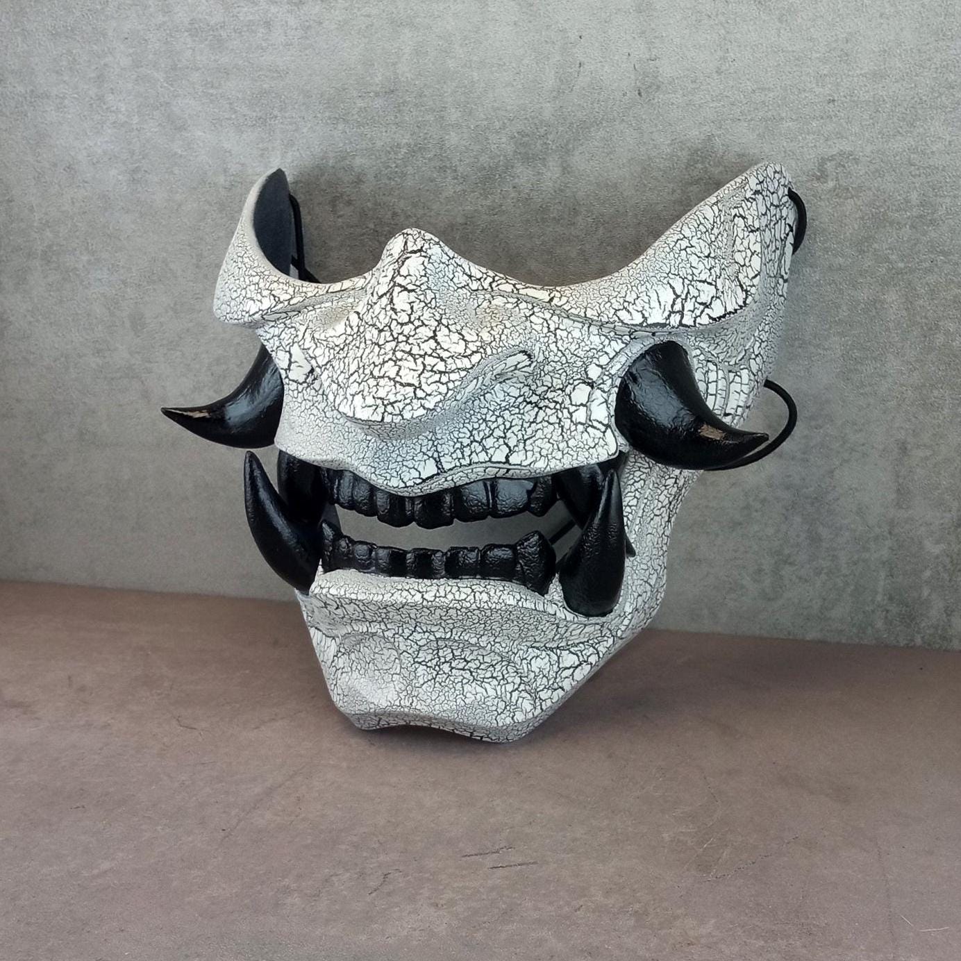 Black and white cracked samurai mask with black fangs