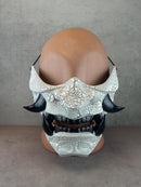 Black and white cracked samurai mask with black fangs