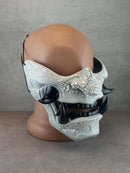 Black and white cracked samurai mask with black fangs