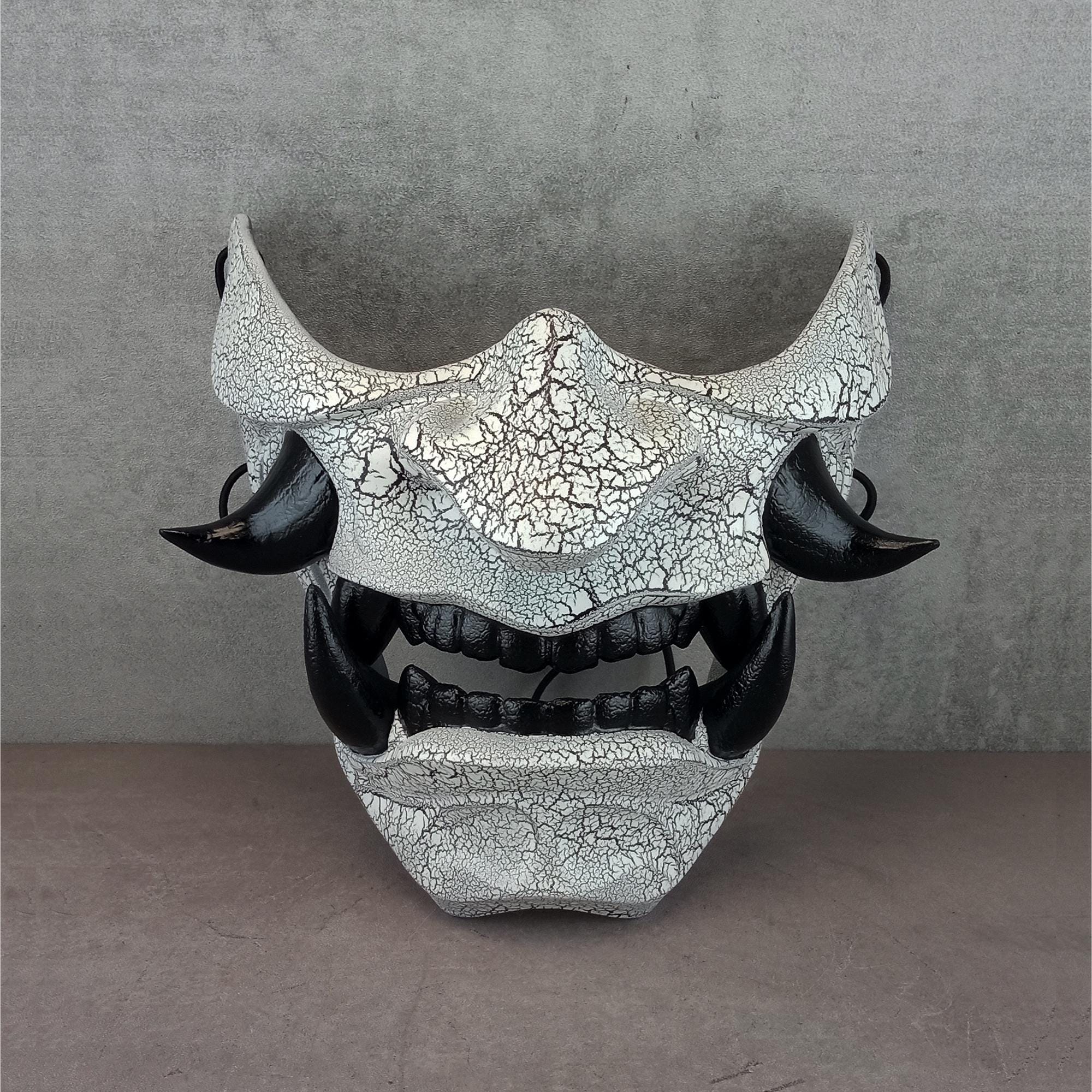 Black and white cracked samurai mask with black fangs