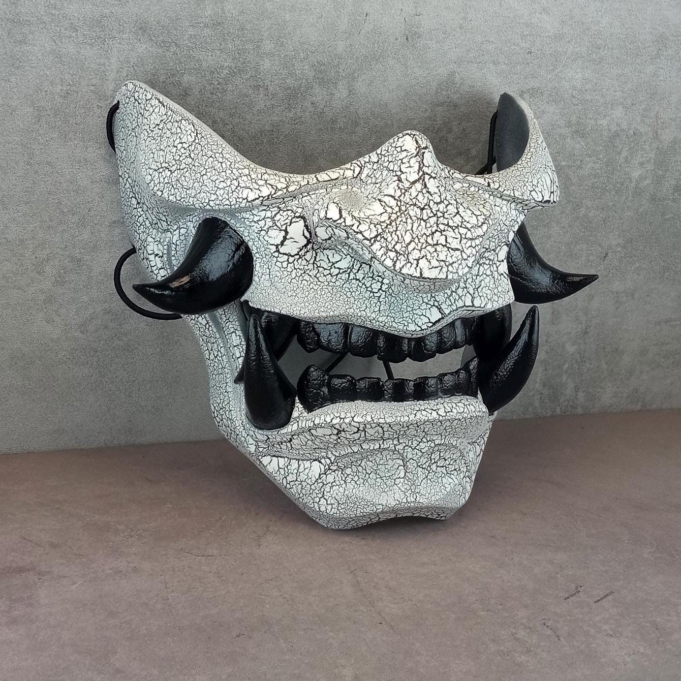 Black and white cracked samurai mask with black fangs