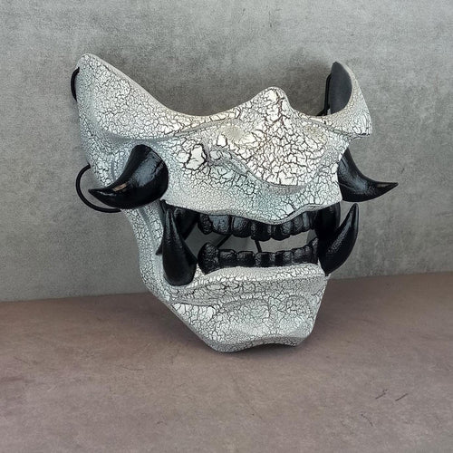 Black and white cracked samurai mask with black fangs